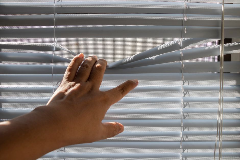 Professional contractor installing modern window blinds
