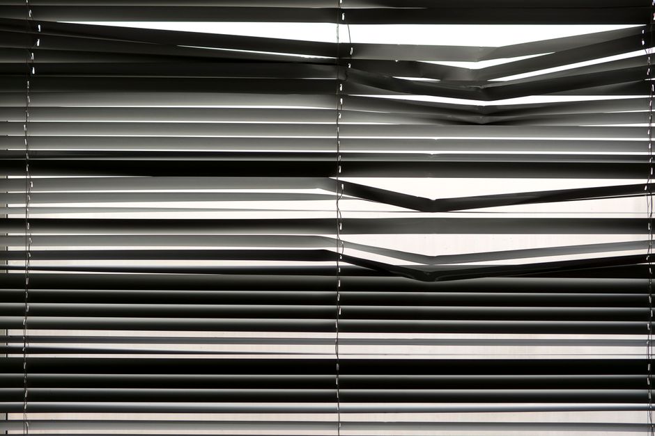 Modern roller shades drawn over a large window
